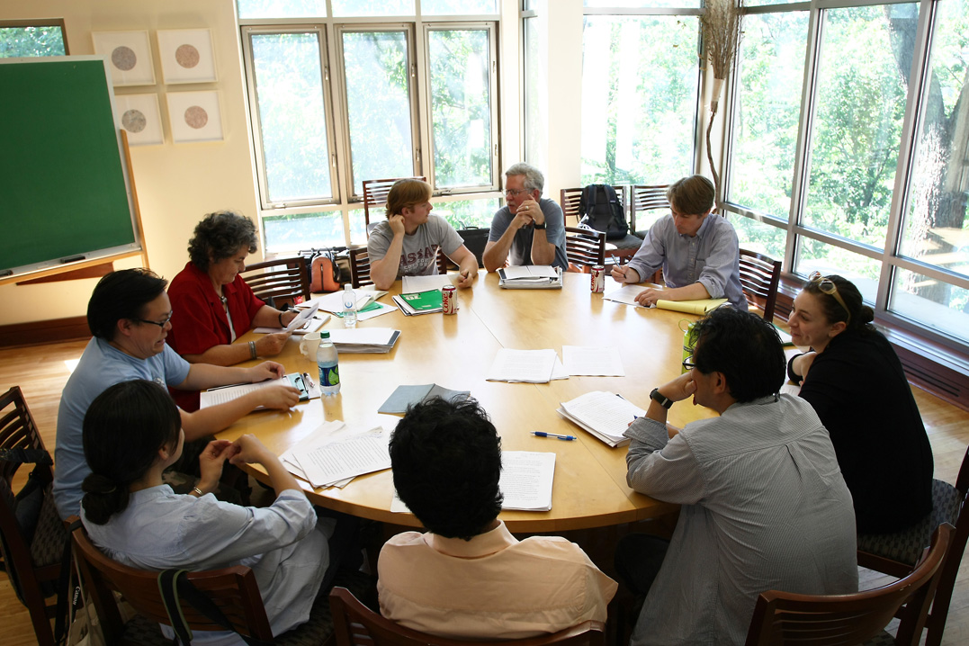writers gathering around a table to discuss content ideas