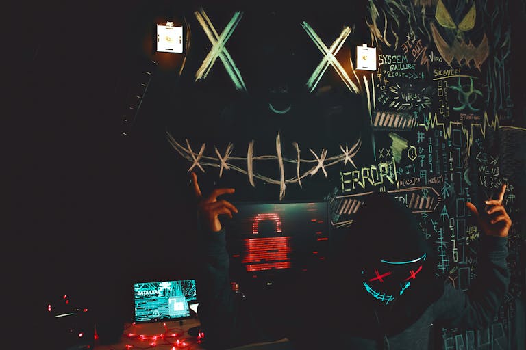 A masked individual in a cyberpunk inspired room filled with graffiti and digital elements.